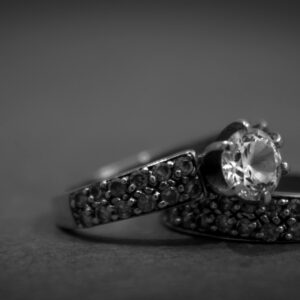 A detailed black and white close-up of elegant engagement rings with diamonds, showcasing luxury and sophistication.