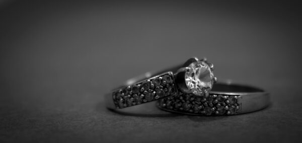 A detailed black and white close-up of elegant engagement rings with diamonds, showcasing luxury and sophistication.