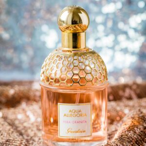 Glistening perfume bottle on a sparkly, elegant background.