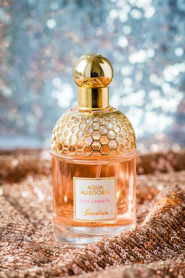 Glistening perfume bottle on a sparkly, elegant background.