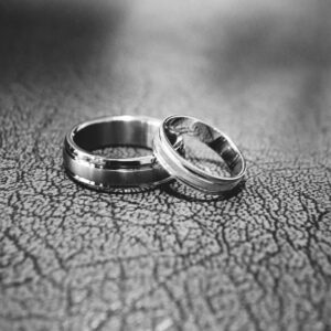 Elegant black and white close-up of wedding rings symbolizing love and commitment.